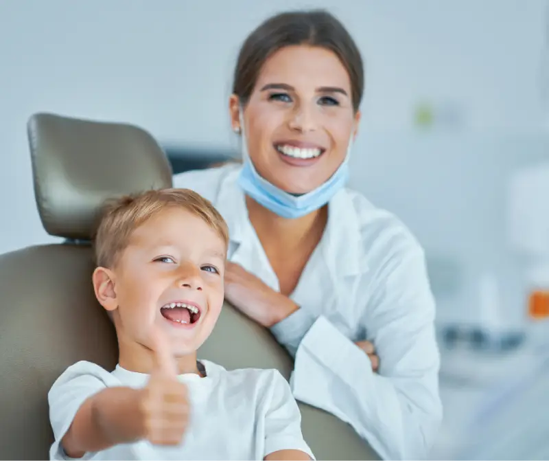 pain free tech kid smiling giving thumbs up with doctor pain free tech kid smiling giving thumbs up with doctor